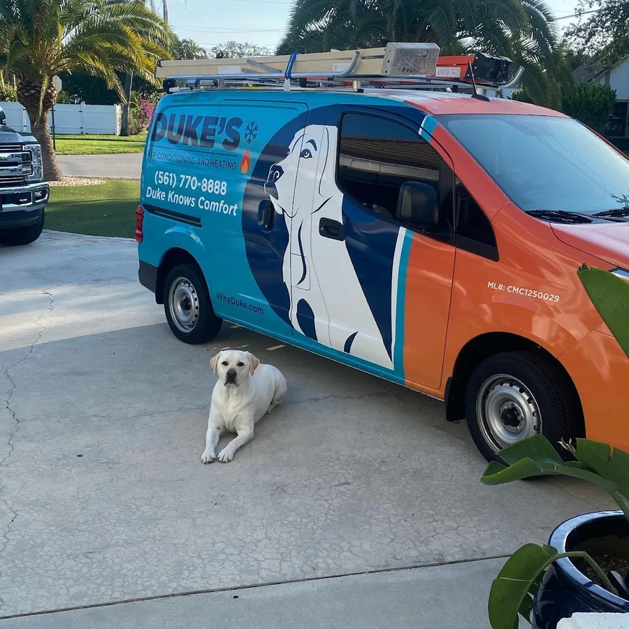 Duke's service van in a residential driveway with Duke the Labrador