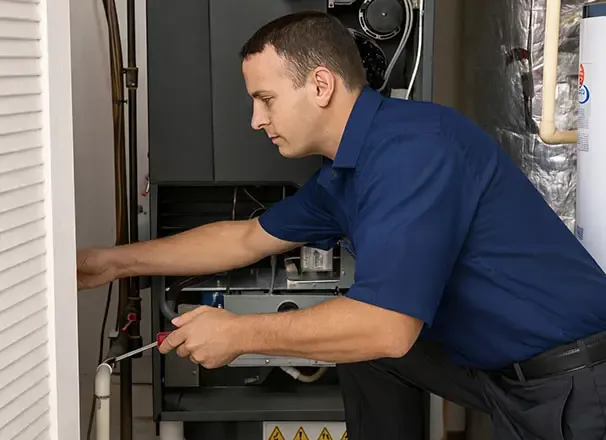 Duke's technician servicing an indoor air handler unit